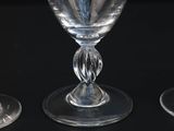 three empty wine glasses sitting on top of a black table