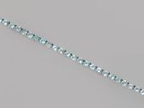 a close up of a blue topaz beaded bracelet on a gray surface