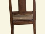 a wooden chair with a woven seat on a white background