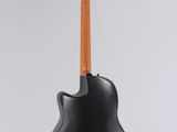 an electric guitar hanging from a stand on a white background