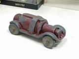 a small toy car sitting on a table next to a book