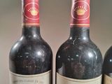 three bottles of wine sitting next to each other on a table