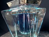 an image of a bottle of perfume sitting on a table