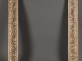 a large carved wood frame with a scroll design