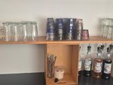 many glasses and bottles on the shelves in the room