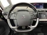 the interior of a car with a steering wheel and dashboard controls