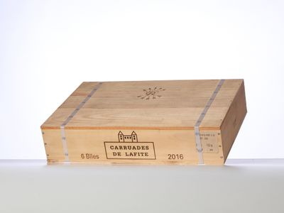 a wooden box with a label on it sitting on a table