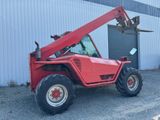 a red tractor with a crane attached to it