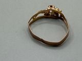 an image of a gold ring on a table