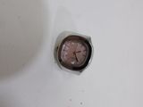 a small clock sitting in the middle of a sink