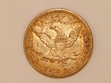 an image of a gold coin on a white surface