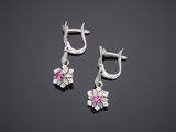 a pair of silver earrings with pink stones on them