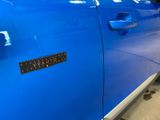 a blue car that has a sticker on it