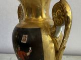 a gold vase with a picture of a man on it