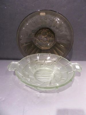un saladier en verre posé sur une table à côté d'une assiette en verre