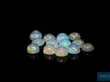 some white oplite stones on a black surface in the dark