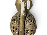 brass figurine of a woman with a bird on her head