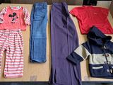 a lot of clothes that are sitting on a table