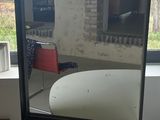 a mirror sitting on top of a table in front of a window