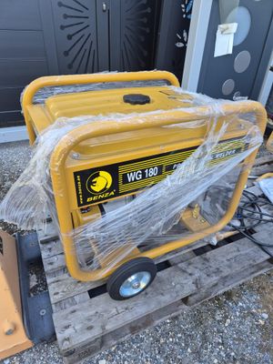 a yellow generator sitting on top of a pallet next to a door