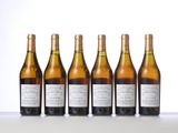 six bottles of wine lined up in a row on a table