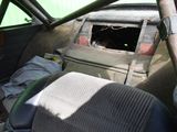 an old car with a broken window in the back of it