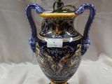 un vase bleu et doré sur fond blanc