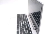 a white laptop with a black keyboard on a white surface
