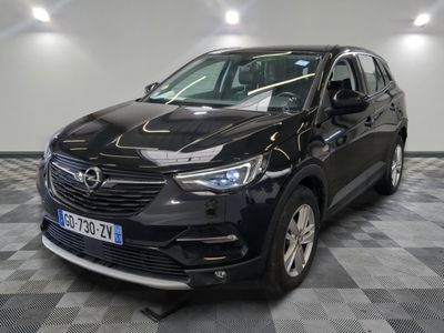 a picture of a black opel parked in a garage