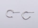a pair of small silver hoop earrings with diamonds on them