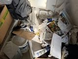 a pile of papers and other items in a room