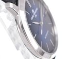 a close up of a wrist watch with a blue face