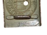 a metal belt buckle with a picture of a seal on it
