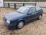 a picture of a blue car parked in a lot
