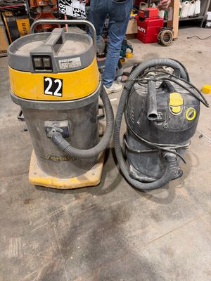 a man standing next to a wet dryer in a garage