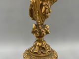 an image of a statue of a woman holding a flower on top of a pedestal
