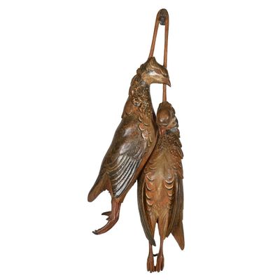 pair of bronze birds on perches on a white background