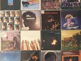 many different album covers on the table together