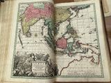 an open book with a map on it on a table