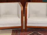 pair of mid - century style chairs with upholstered arms
