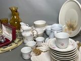 a lot of dishes and cups on the table