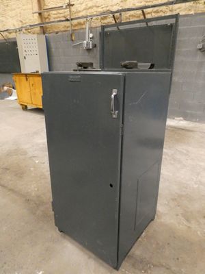 a metal cabinet in the middle of a room