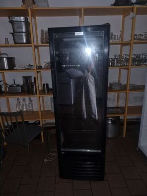 someone is taking a picture of a refrigerator in a kitchen