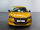 the front of a yellow car is parked in a showroom