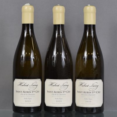 three bottles of wine are lined up on a table