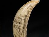 two pieces of ivory with a drawing of a boat on it