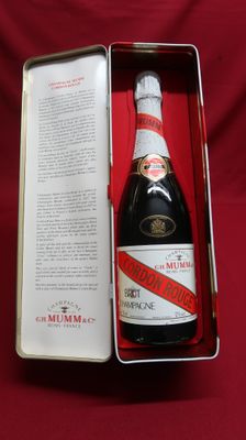an open box with a bottle of champagne in it on a red cloth