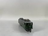 a green train on the tracks on a white background