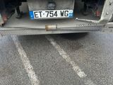 a rusted truck with a license plate on the back of it