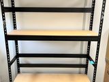 a black shelving with wooden shelves in a room